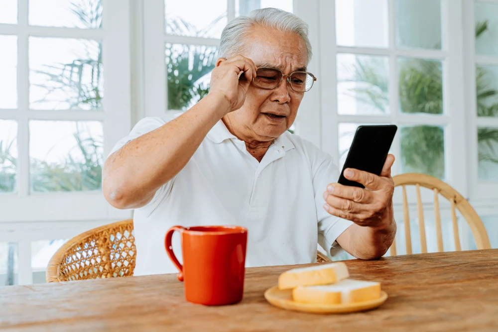 Elderly man experiencing blurred vision from cataracts.